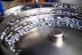 Metal parts being sorted in a wheel